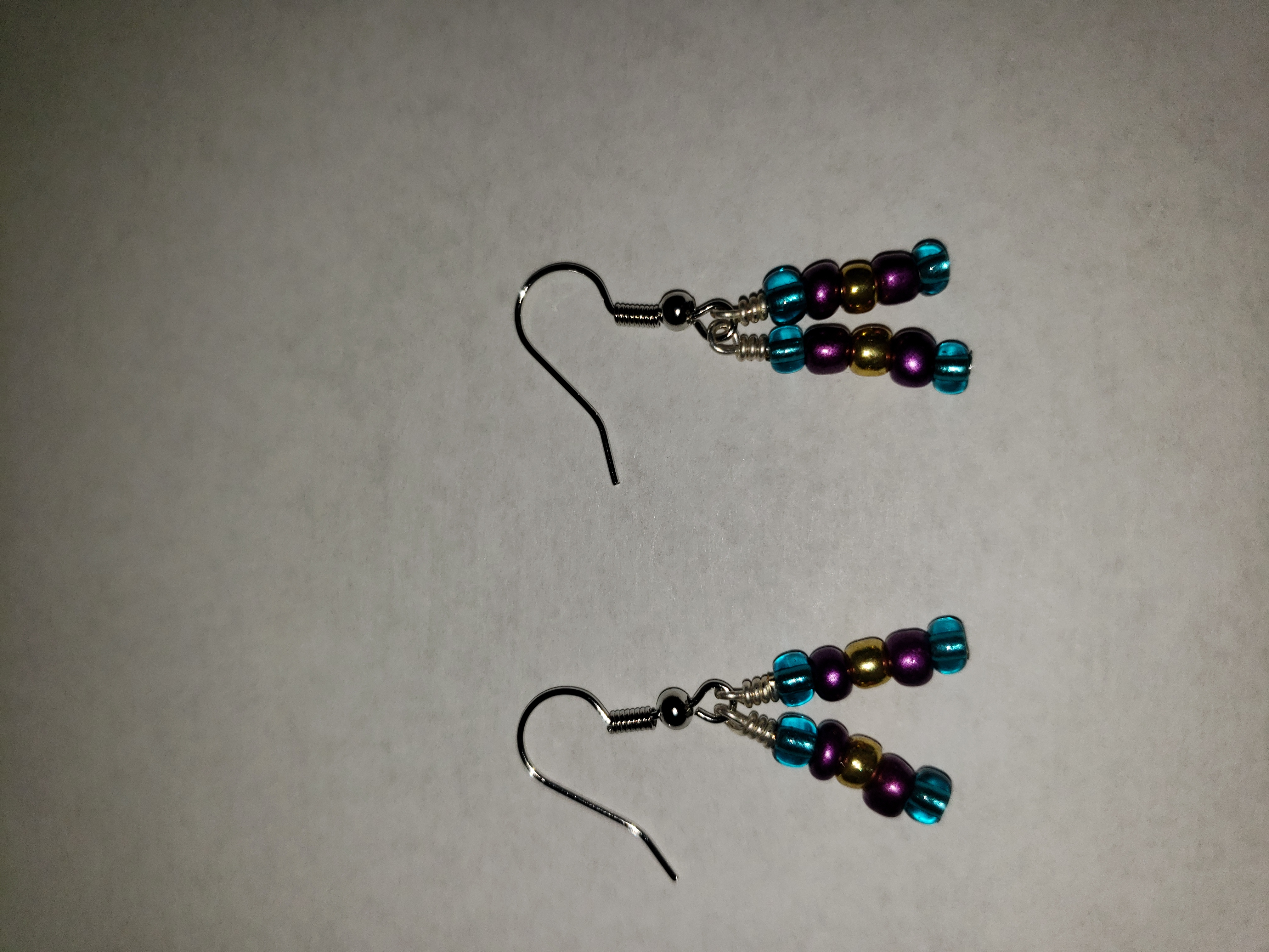 Dangle earrings; teal, purple, and gold.